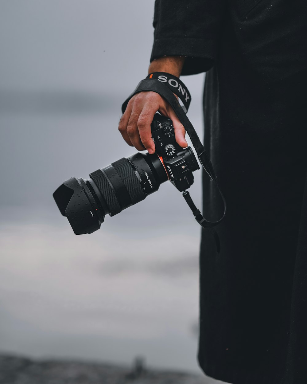 person holding black dslr camera