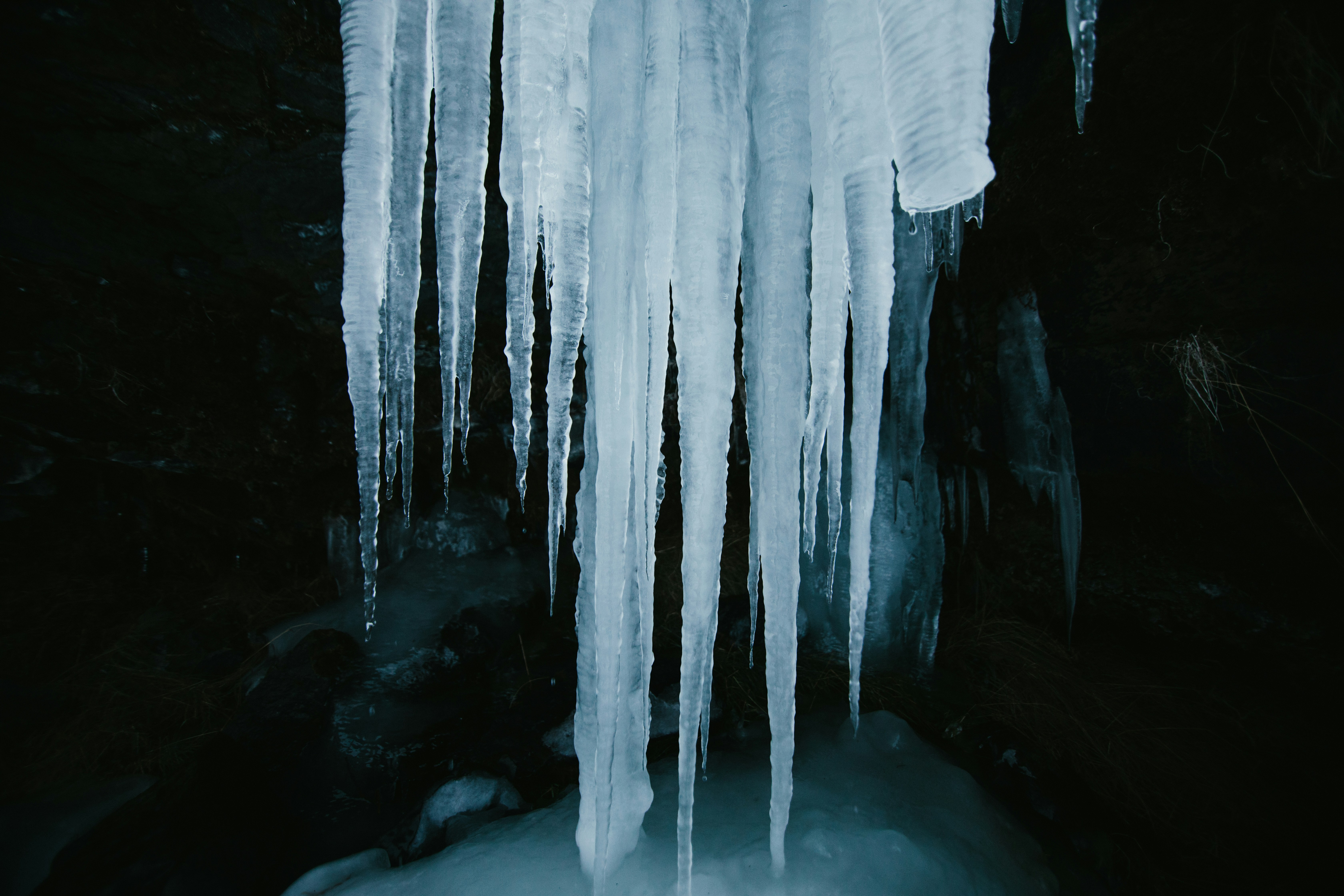white and black cave with water icicle teams background