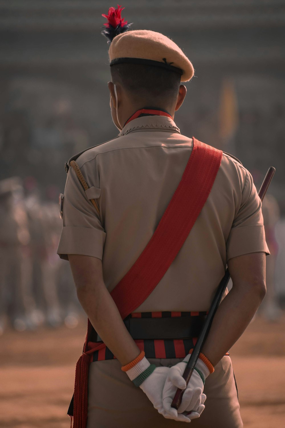 man in brown shirt with red and black backpack