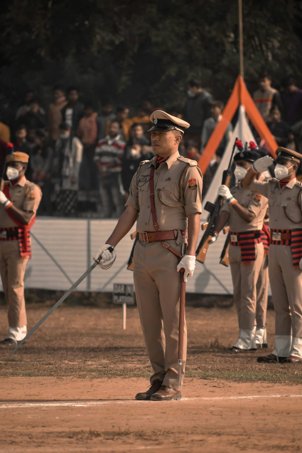 men in red and white uniform holding rifle during daytime