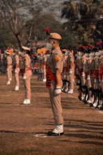 soldiers in brown uniform standing on brown field during daytime