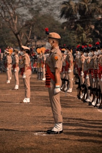 soldiers in brown uniform standing on brown field during daytime