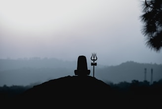 A serene and devotional image of Lord Shiva meditating in the Himalayas at dawn.