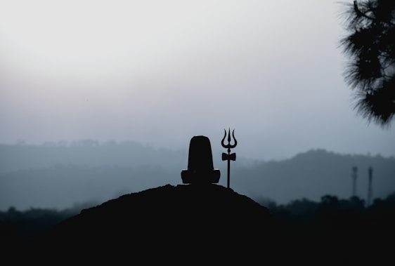 A serene and devotional image of Lord Shiva meditating in the Himalayas at dawn.