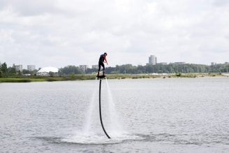 A person flying on an AquaVel jetpack over water.