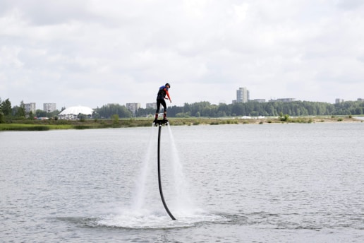A person flying on an AquaVel jetpack over water.