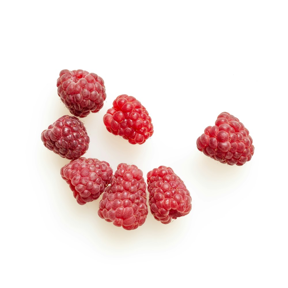 red round fruits on white surface