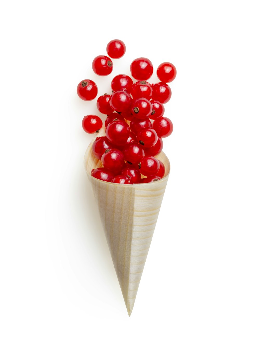 red cherries on brown wooden cone