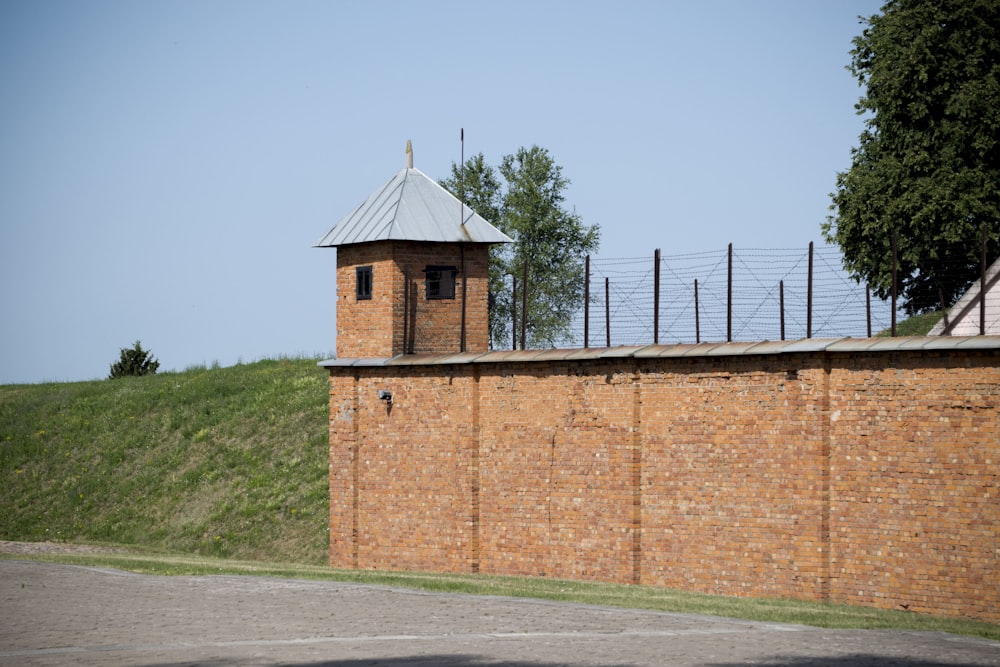 brown brick building near green grass field during daytime