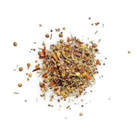 A close-up view of a mix of dried herbs and spices scattered on a white background. The mixture includes various seeds such as coriander and peppercorns, alongside coarse, shredded leaves and pieces of dried orange peel.