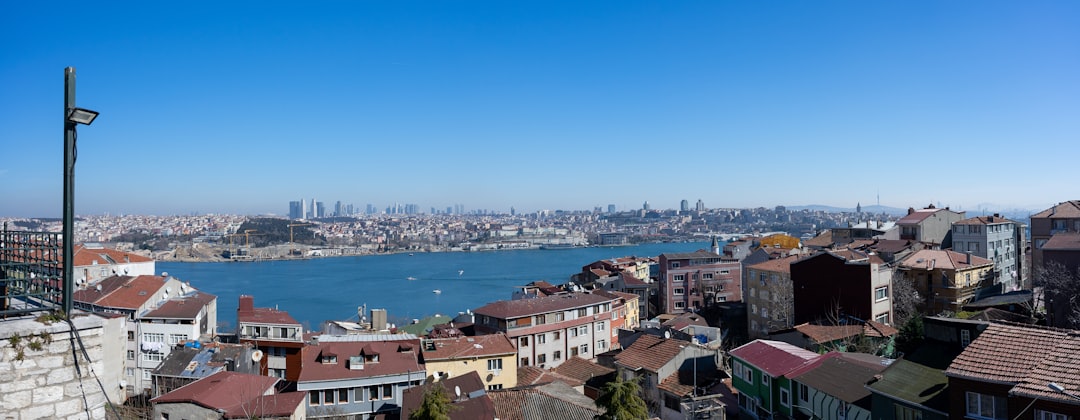 aerial view of city buildings near body of water during daytime