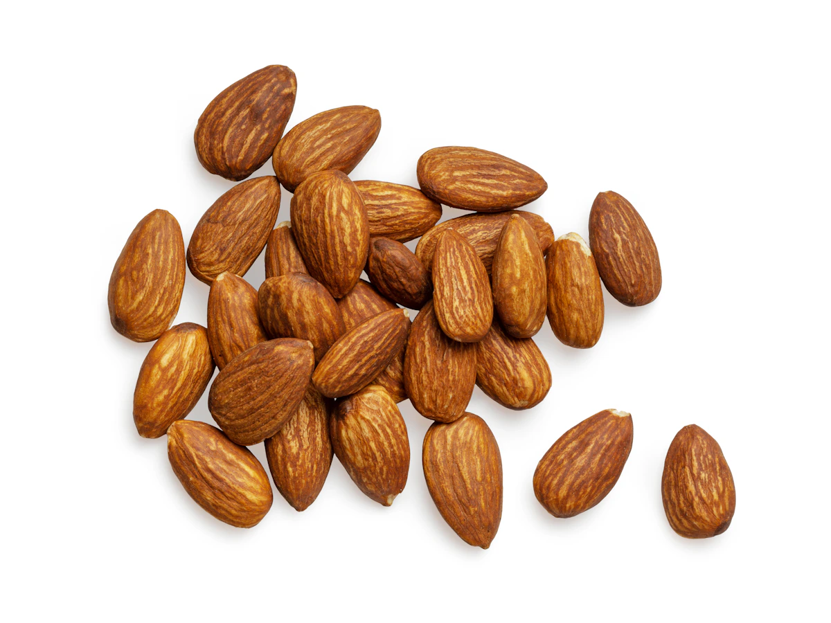 Whole almonds arranged on a warm neutral surface