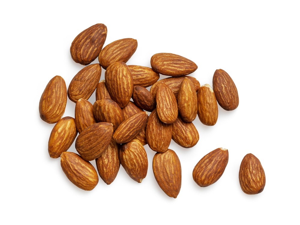 brown almond nuts on white background