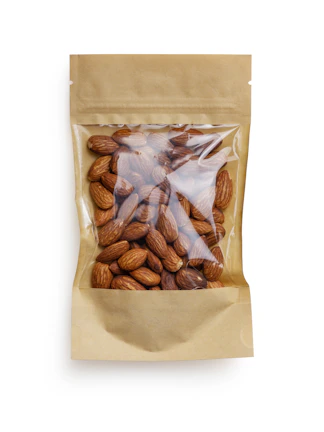 Elegant packaging of Nobleza Verde pistachios with earth-tone and gold accents on a natural linen background.