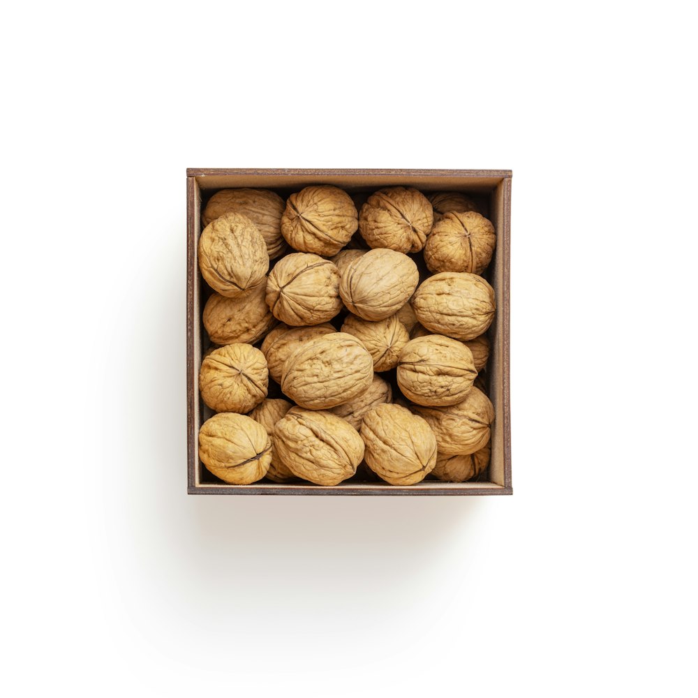 brown almond nuts on white surface