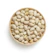 Bright, inviting photo of a bowl filled with green pistachios on a kitchen counter.