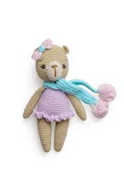 A baby teddy bear with soft pastel colors and embroidered eyes.