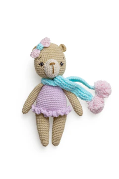 Close-up of a handmade crochet teddy bear with soft pastel colors.