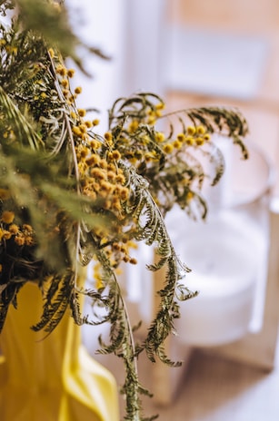 Close-up of a graduation bouquet with bright yellow sunflowers and delicate greenery.