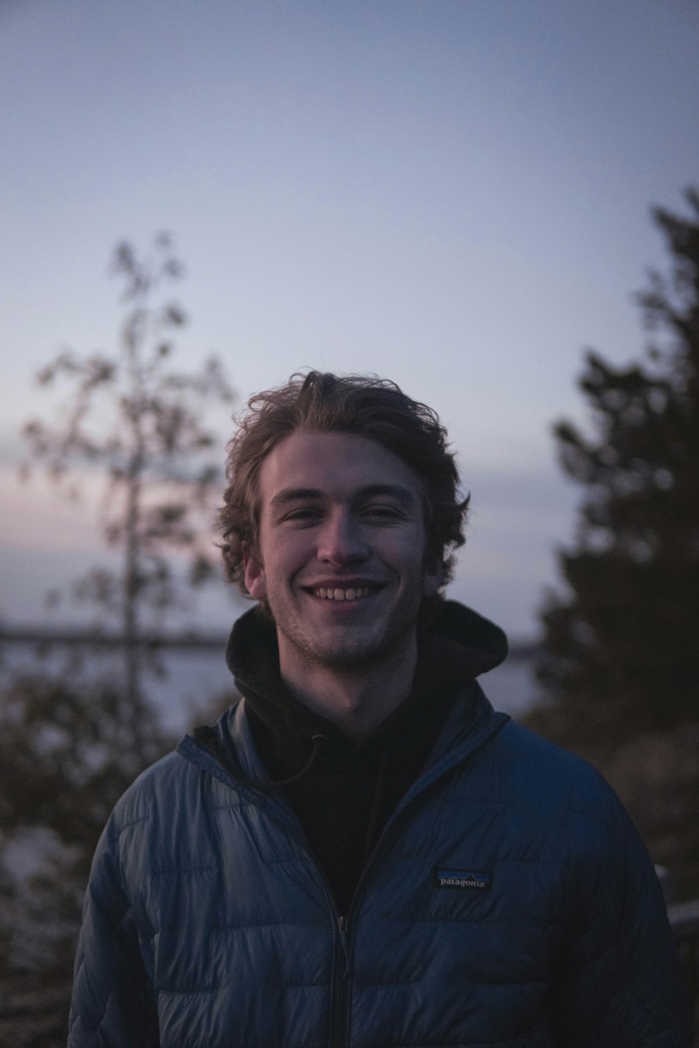 man in blue jacket smiling