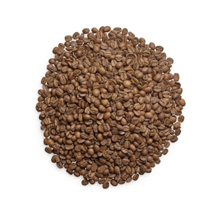 A large pile of roasted coffee beans arranged in a circular shape against a white background. The coffee beans are evenly distributed, showcasing their rich brown color and detailed textures.