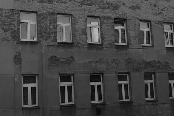 Close-up of a high-rise building facade showing detailed cracks and wear detected by AI inspection.