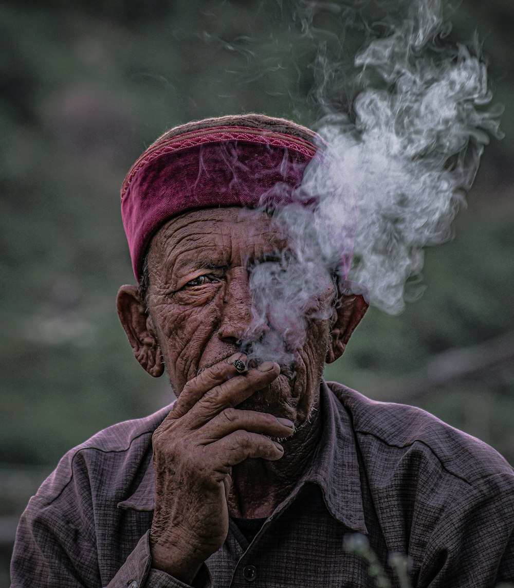 man in gray jacket smoking