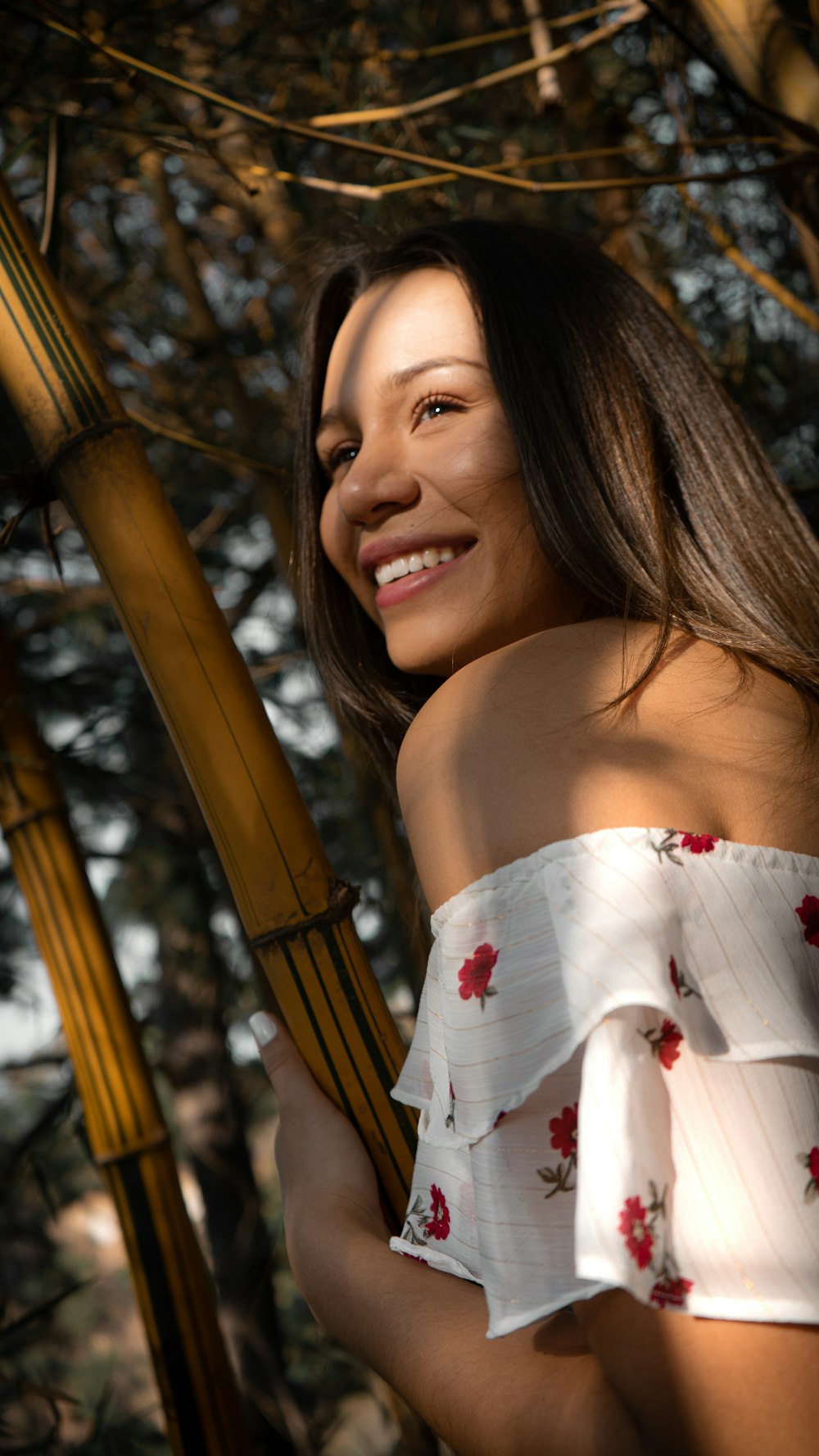 woman in white and red floral off shoulder dress