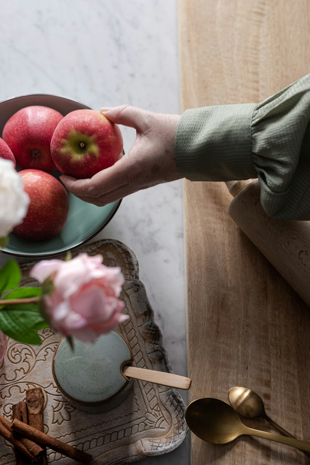 person holding red and green apple fruit