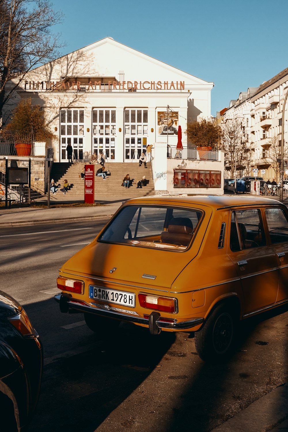 orange volkswagen beetle on road during daytime