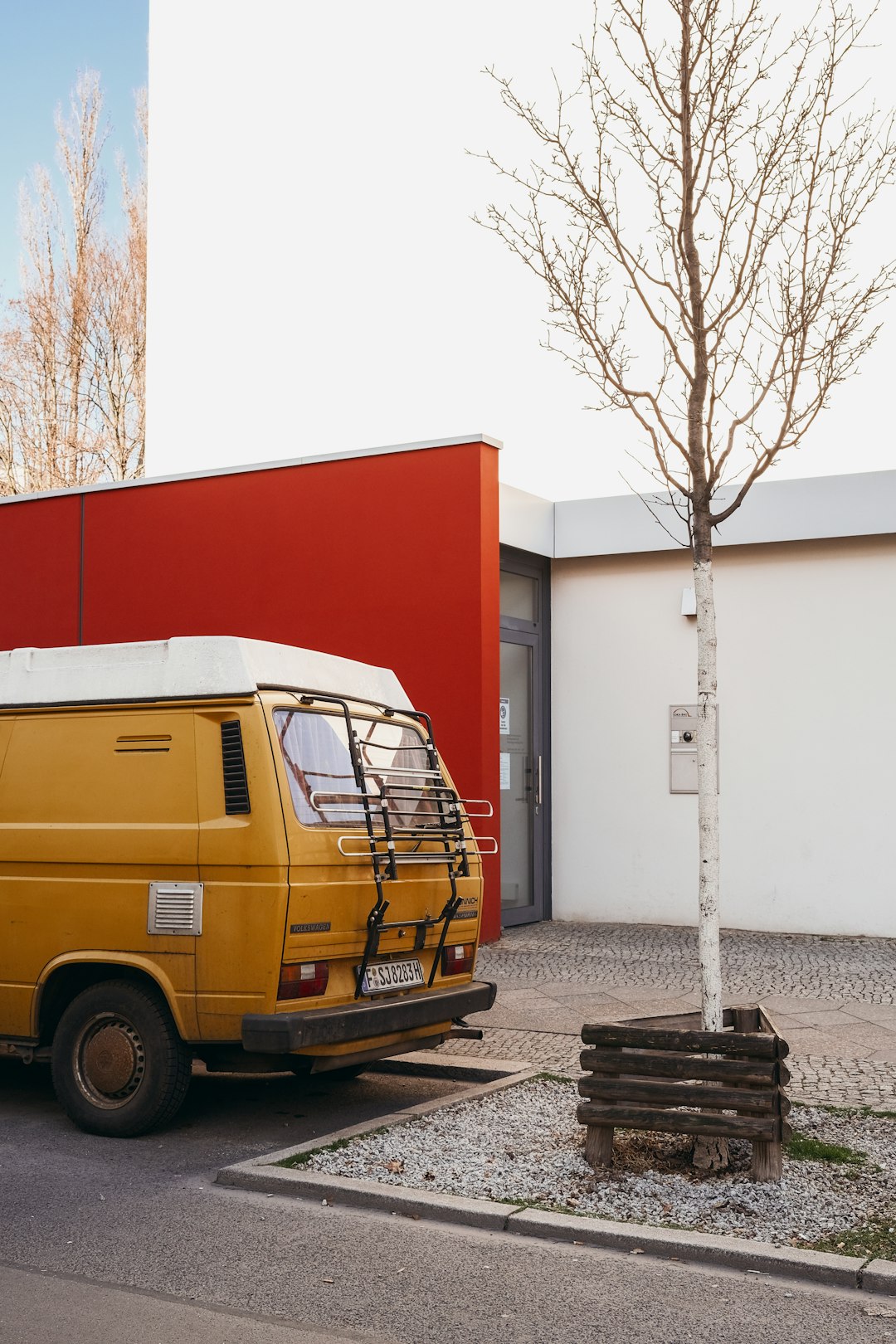 yellow van parked near white and red building