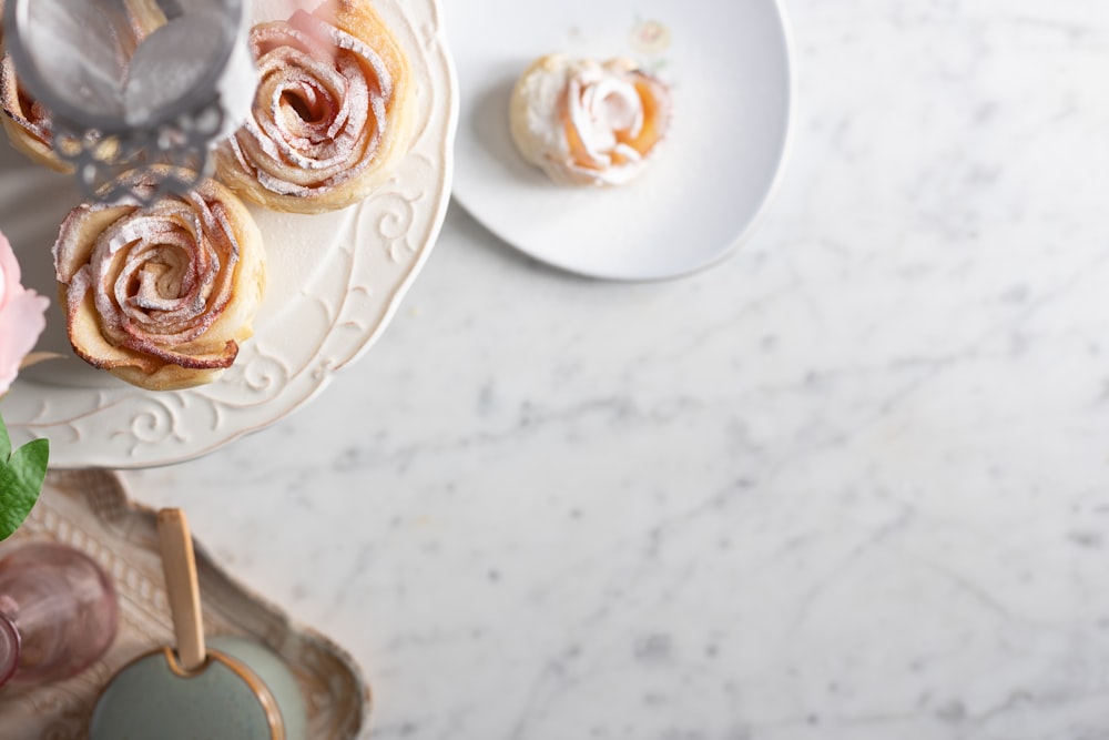 white and brown floral ceramic teacup on white saucer