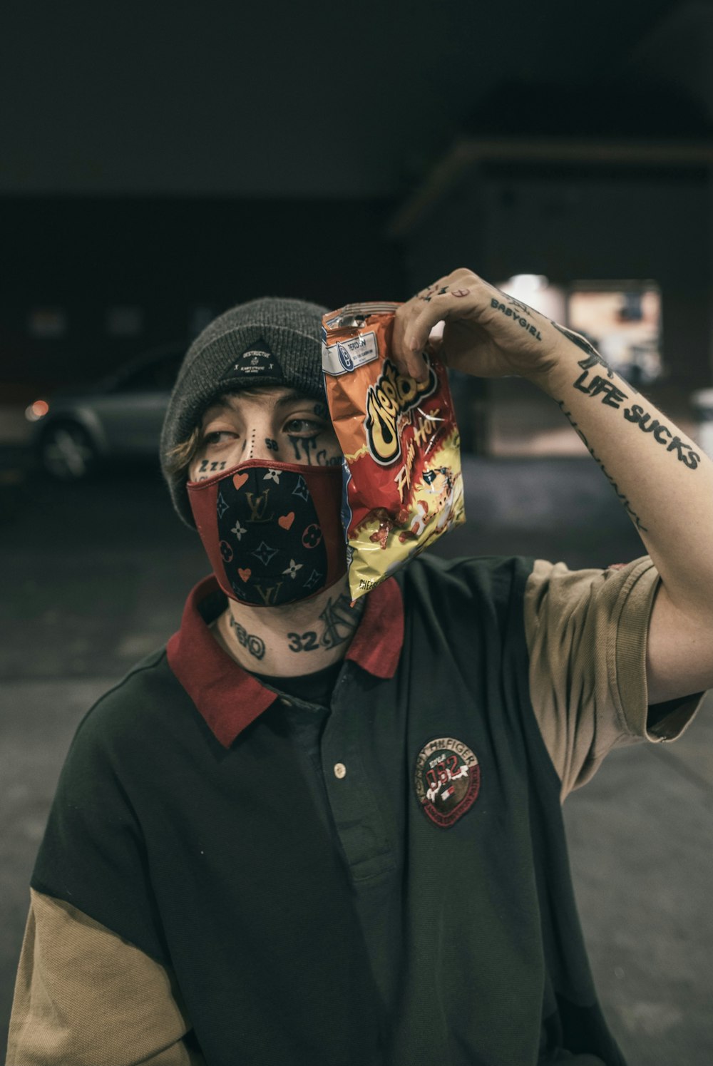 man in black button up shirt wearing black knit cap holding red and white  mask photo – Free Image on Unsplash