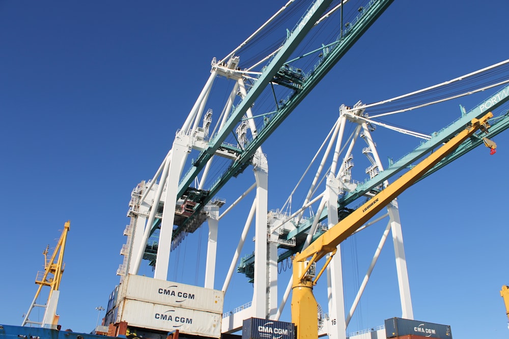 white and yellow crane under blue sky during daytime