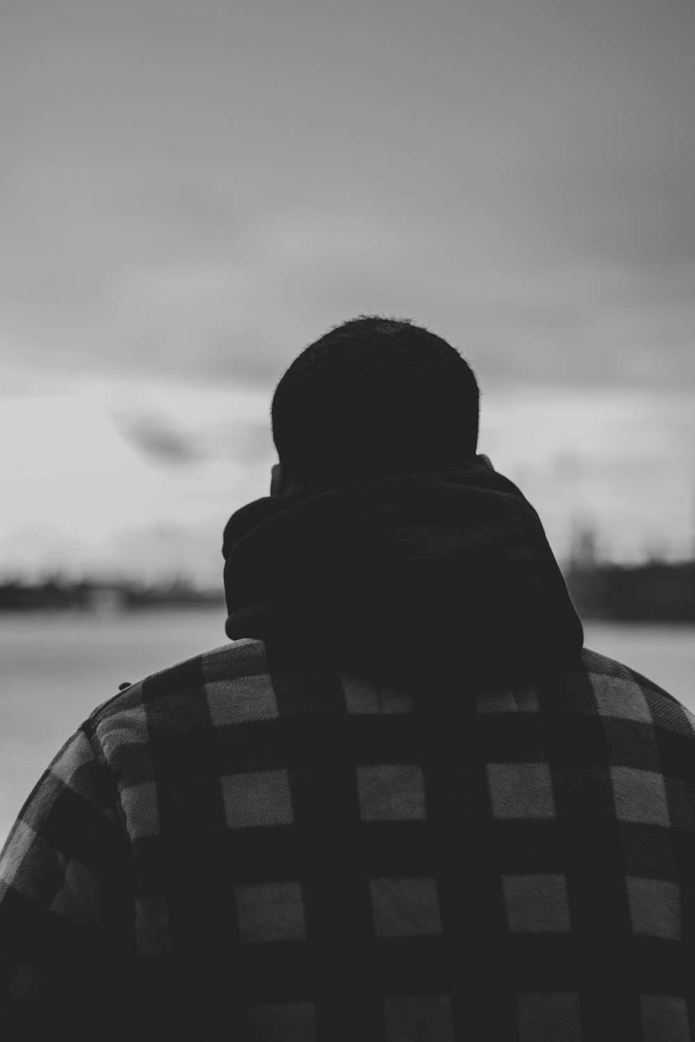 man in black and white checkered hoodie