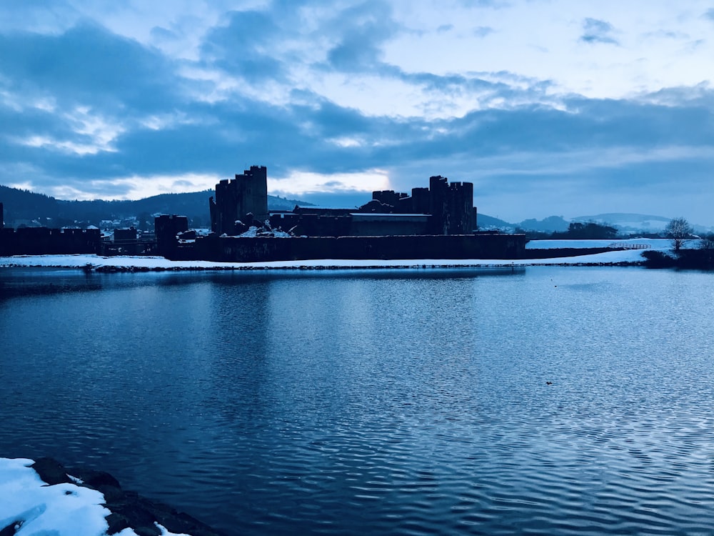 body of water near buildings under cloudy sky during daytime