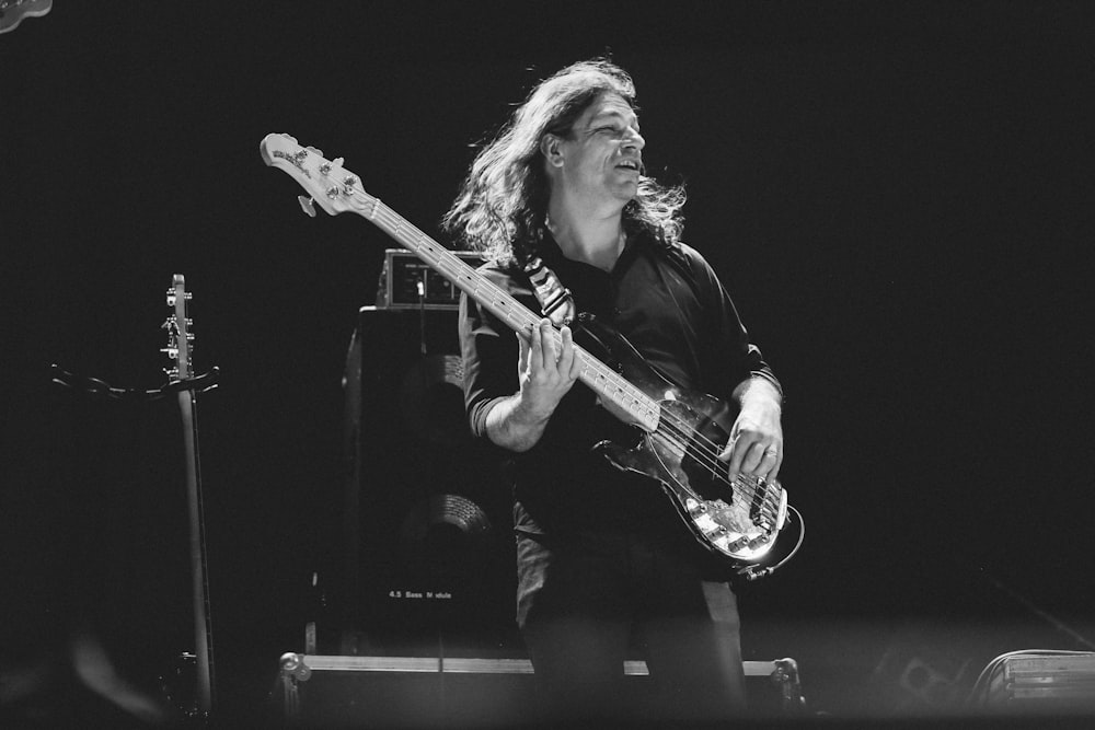 man playing guitar on stage