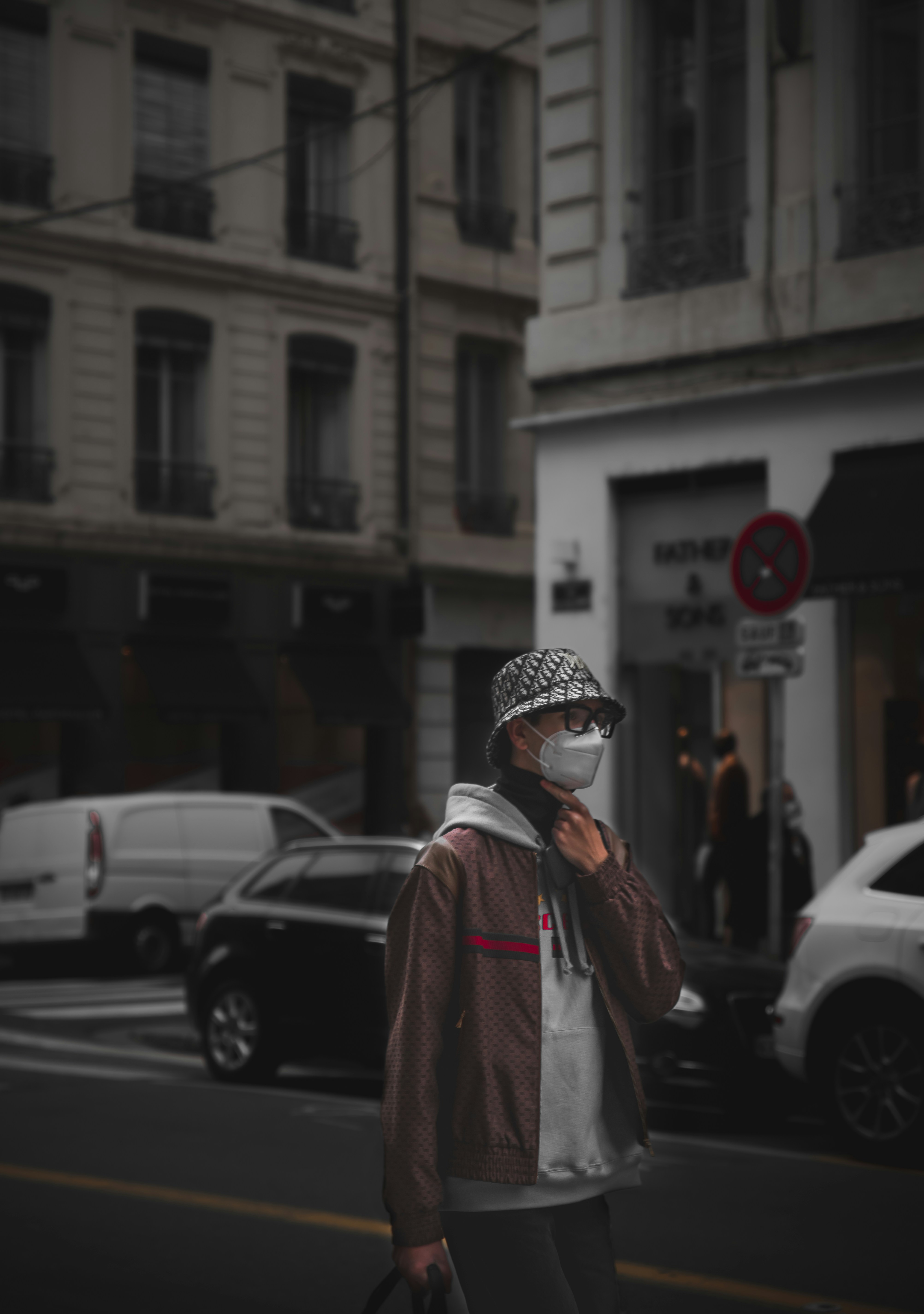 woman in red coat standing near white car during daytime