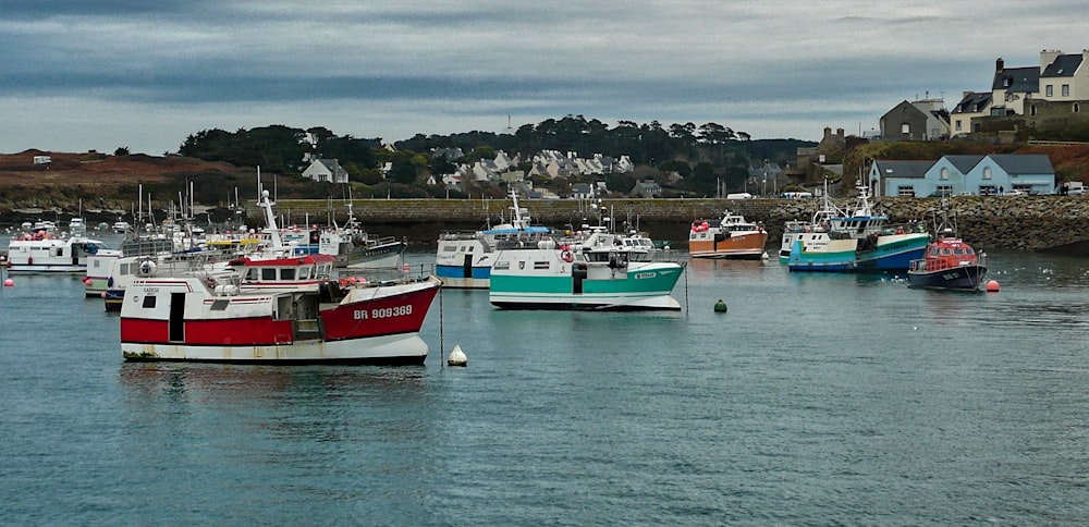 white and red boat on sea under gray sky during daytime