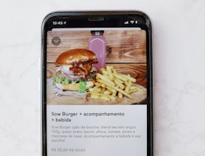 burger and fries on black and white tray