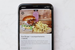 burger and fries on black and white tray