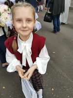 A smiling young girl holding her journal and matching t-shirt gift kit wrapped neatly