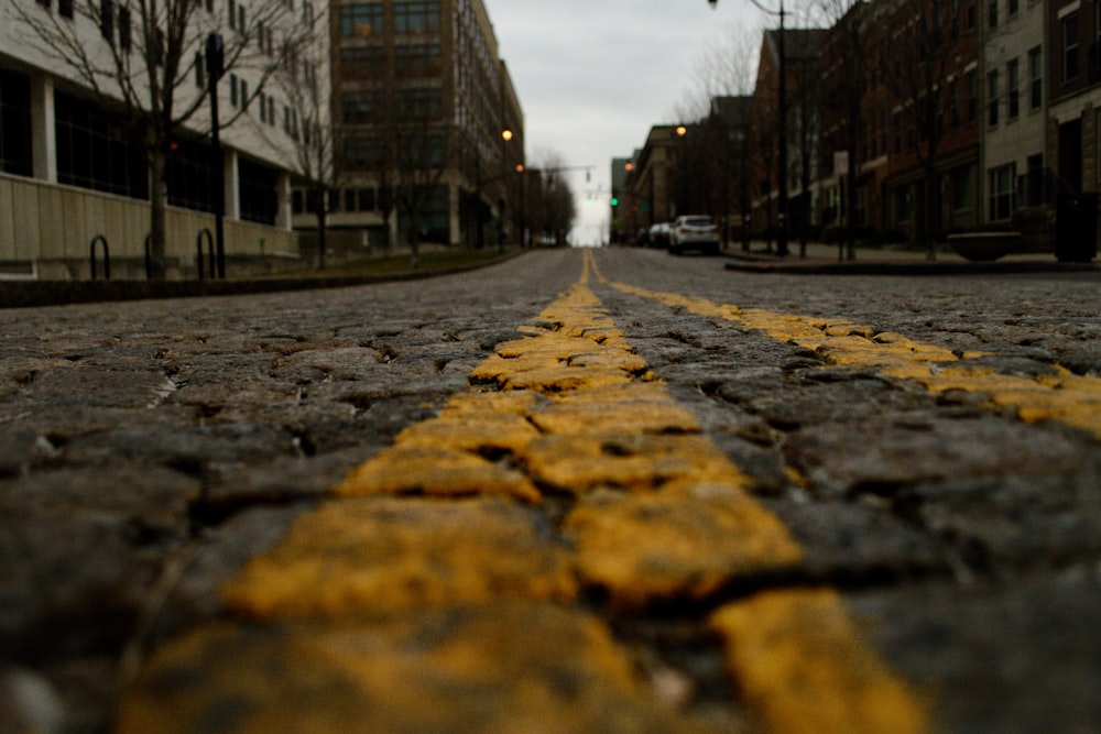 gray concrete road between buildings during daytime