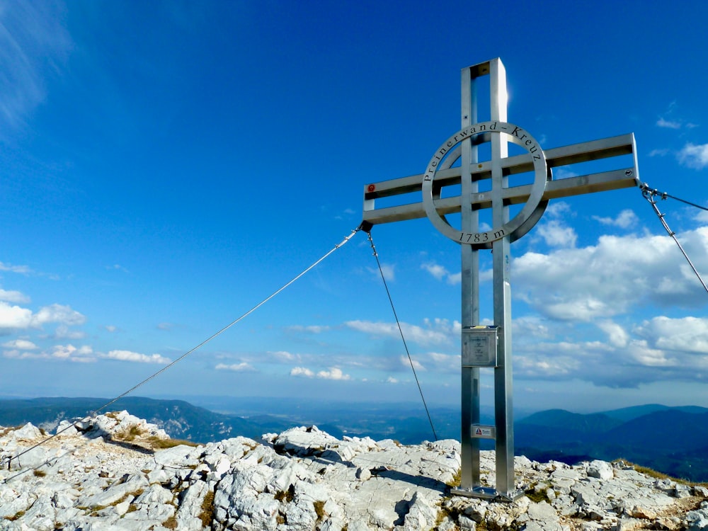 gray metal post on snow covered ground under blue sky during daytime