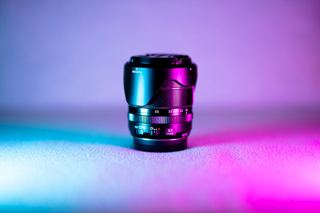 black camera lens on pink and white table