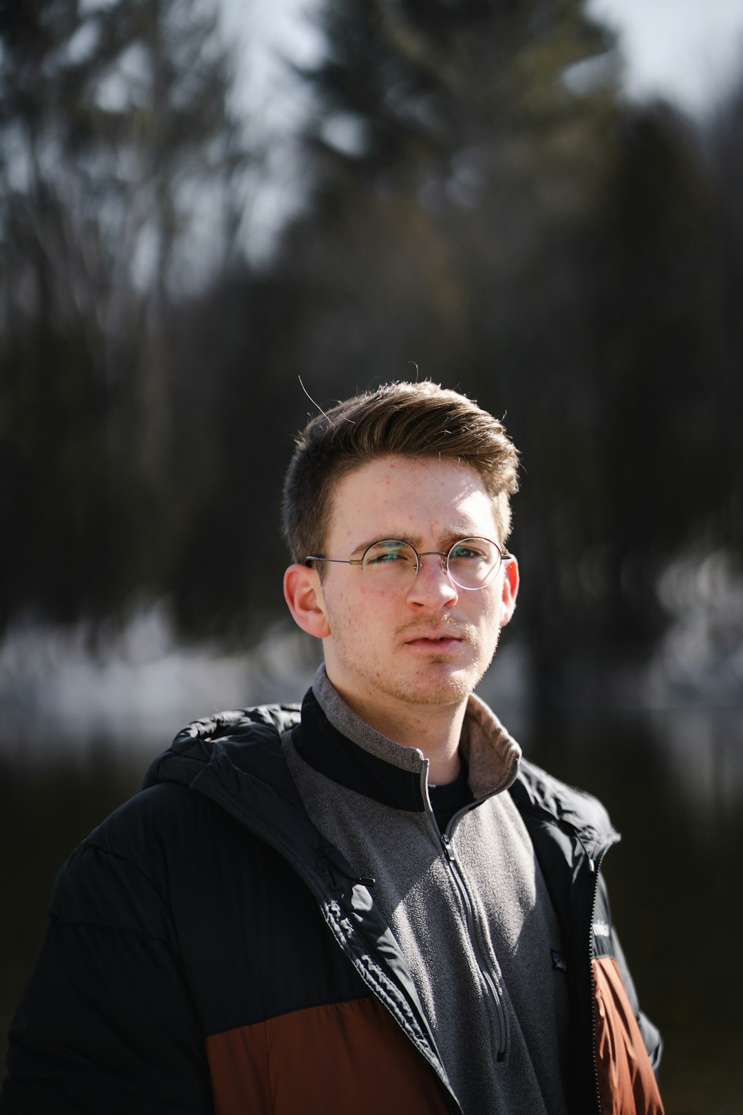 man in black jacket wearing eyeglasses