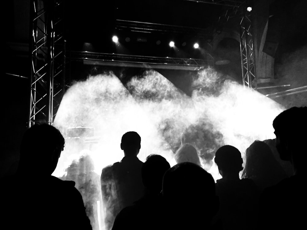 silhouette of people standing on stage