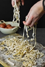 person holding stainless steel fork and knife slicing vegetable
