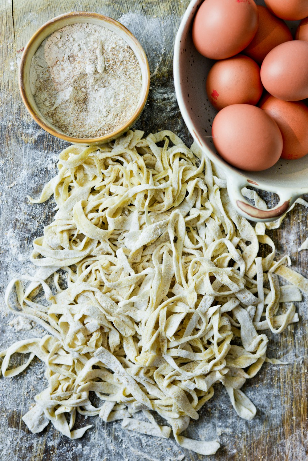 white pasta on stainless steel bowl