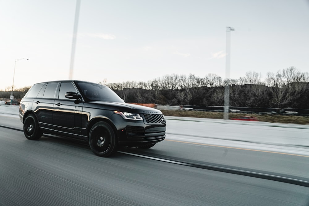 black suv on road during daytime